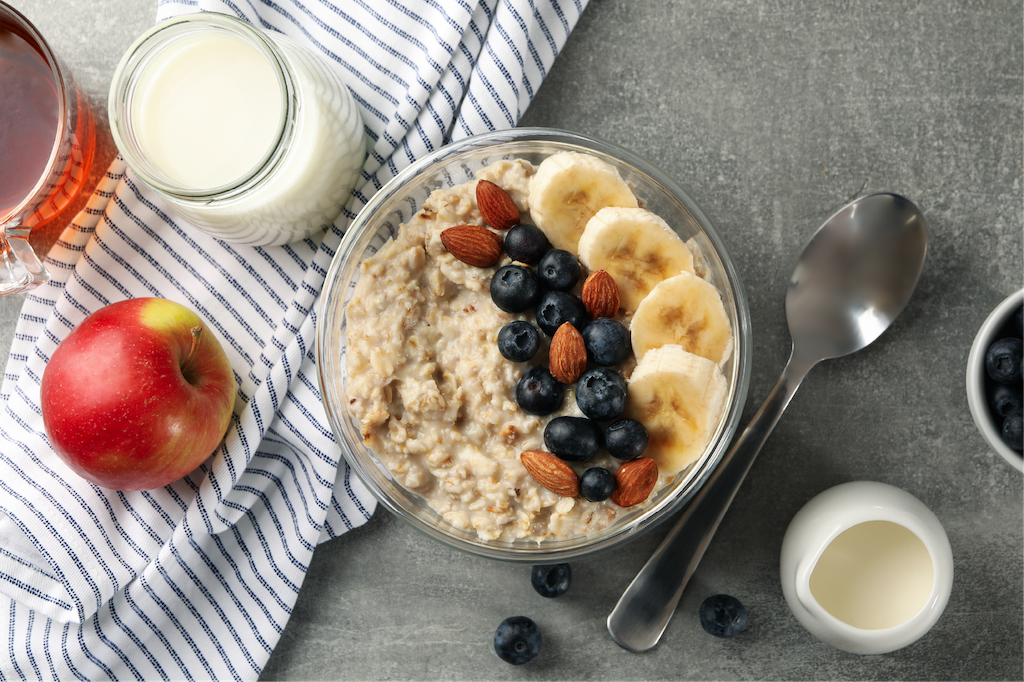 Bowl of oatmeal topped with berries and banana slices.